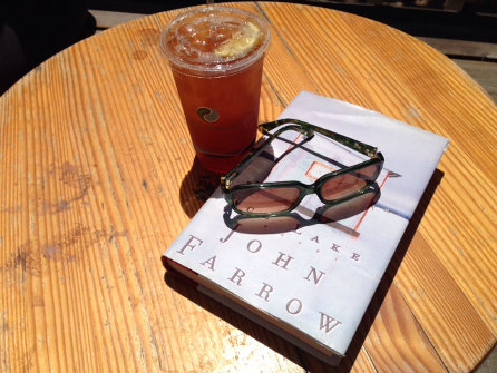 table with book, sunglasses and iced tea