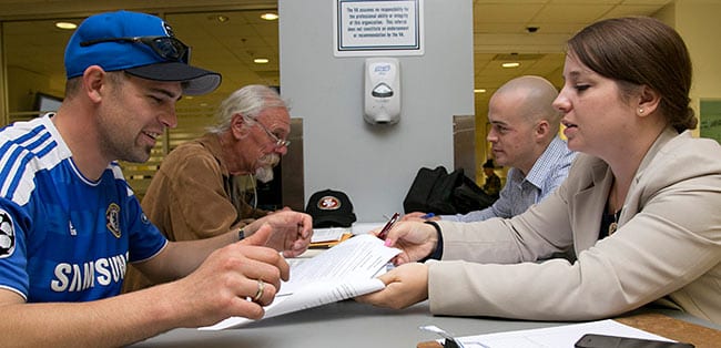 Berkeley Law clinic students Adrian Kinsella and Heather St. Clair meet with veterans. Photos by Jim Block