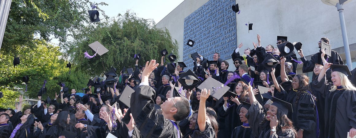 Graduates throwing caps in the air