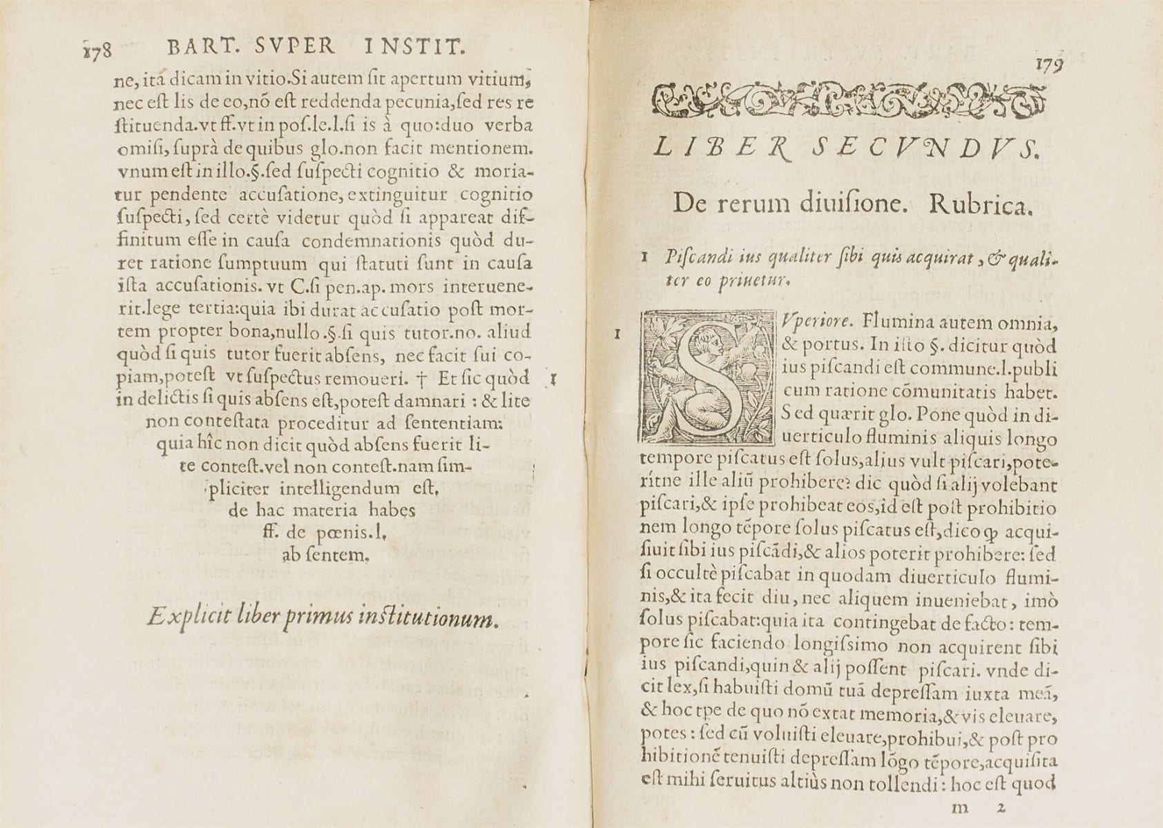 Two-page book spread with latin text and embellished letters. Links to larger version of this image.
