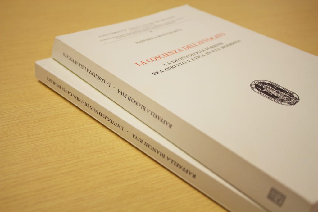 Photograph of two of Dr. Bianchi Riva's published books placed on a table.