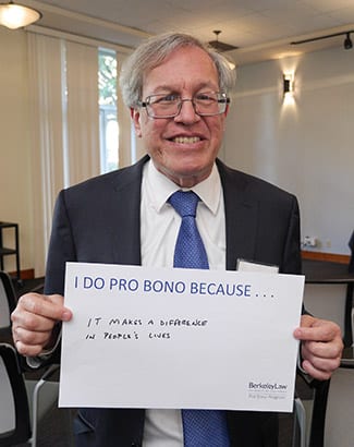 Dean Erwin Chemerinsky holding sign "I Do Pro Bono Because...it makes a difference in people's lives."