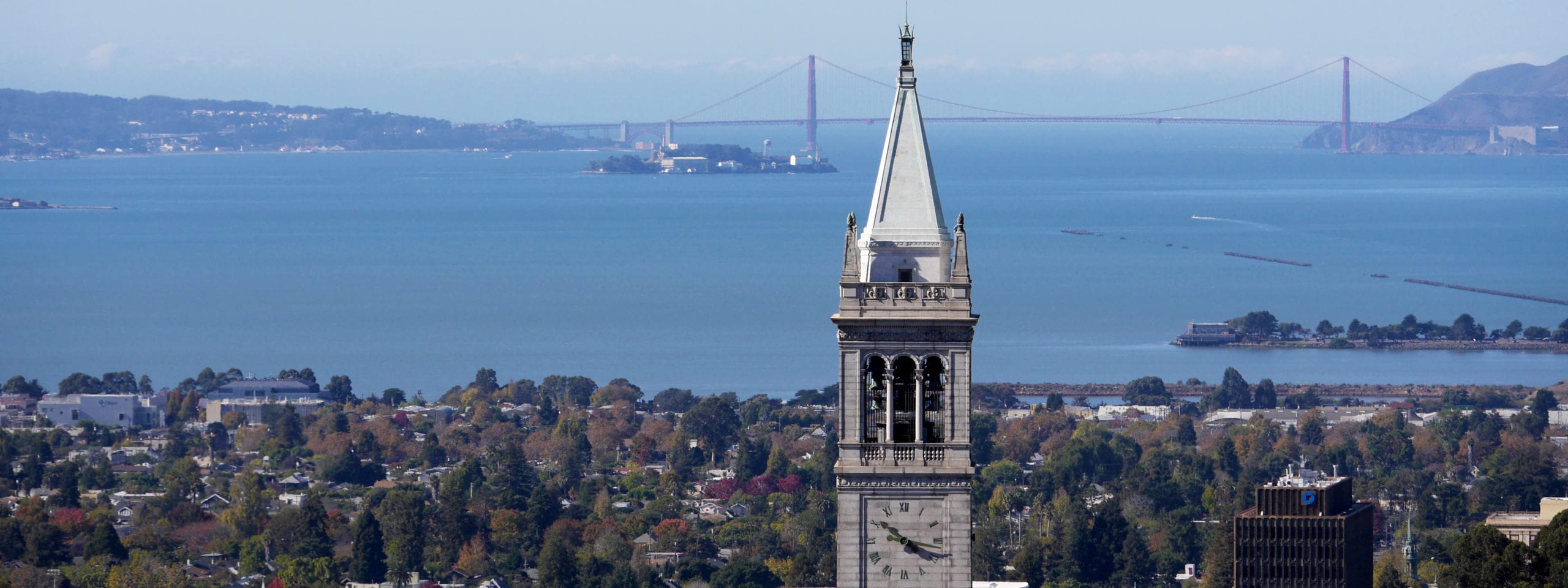 Berkeley Campanile in foreground with bay and Golden Gate Bridge in background