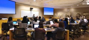 People listening to speaker in classroom