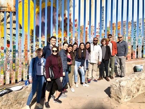 BLAST Tijuana 2019 participants with Border Wall Muralist Enrique Chiu.