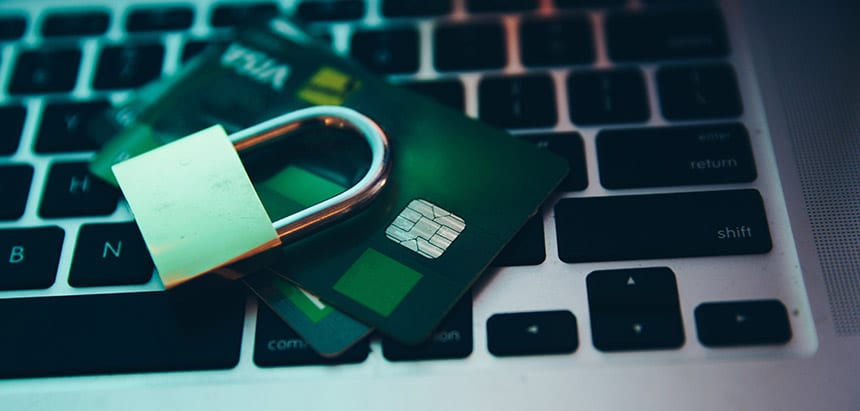 Image of lock on top of credit cards on top of laptop keyboard