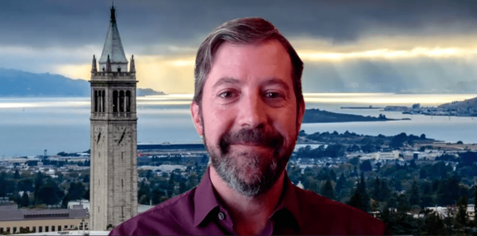 Image of speaker and campanile clock tower. Links to video recording of presentation