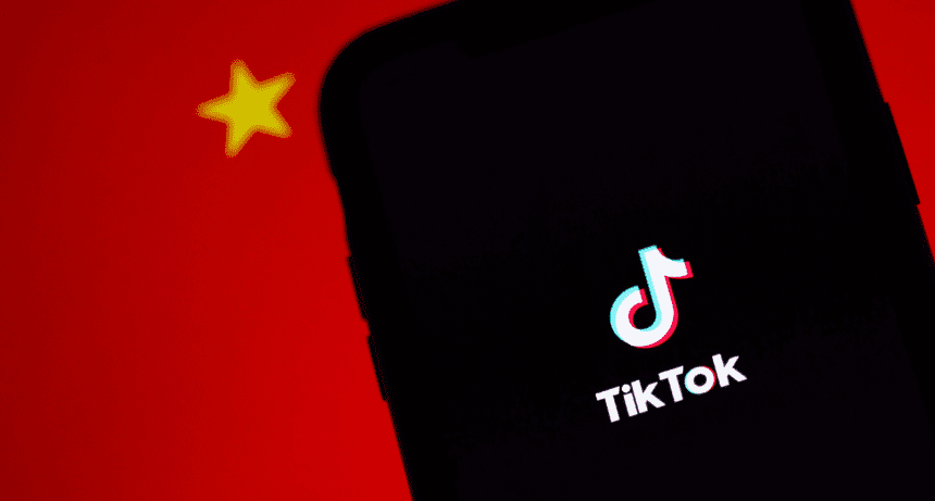 phone with tiktok app against chinese flag