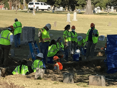 Workers excavating in cemetery
