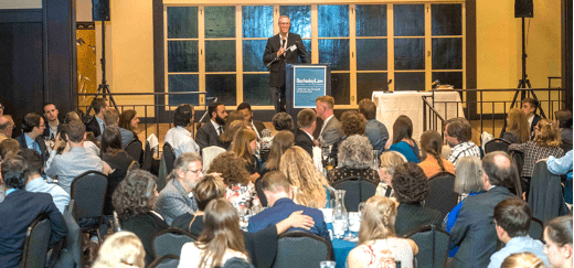 Image of Representative Jared Huffman on stage addressing the audience at the 2019 Environmental Awards Banquet
