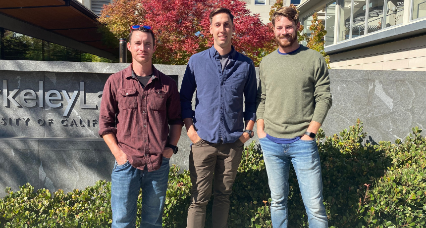 three men standing outside