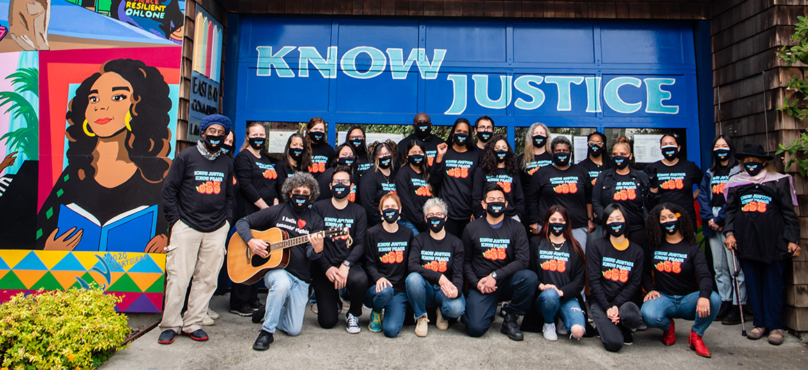 EBCLC banner: group photo in front of "Know Justice" sign