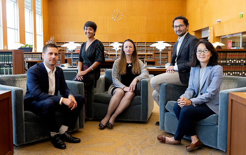 Faculty members seated in library