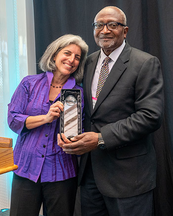 Claudia Polsky and Robert Bullard holding award