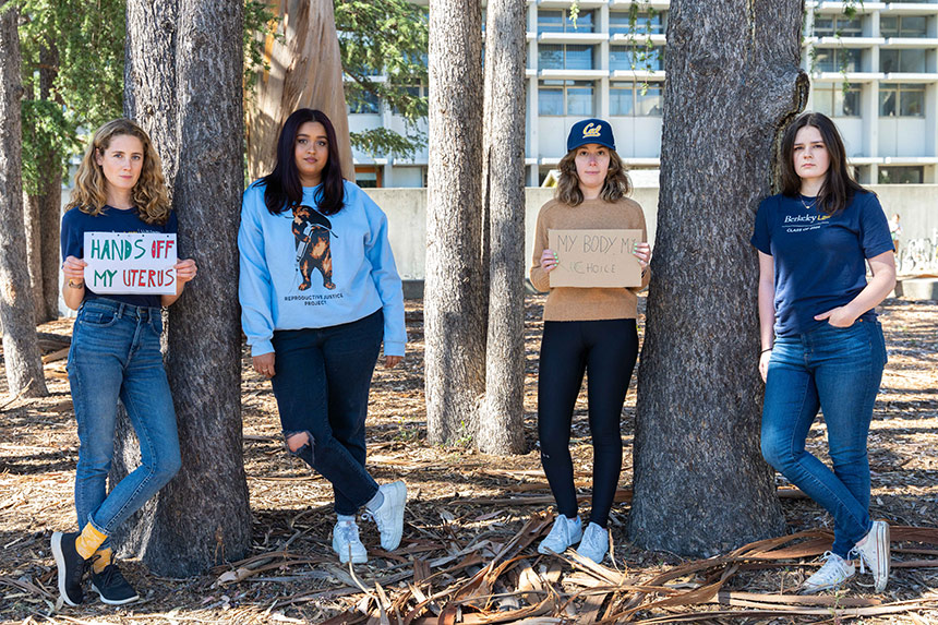 Four women students with signs