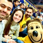People at sporting event with mascot bear Oski