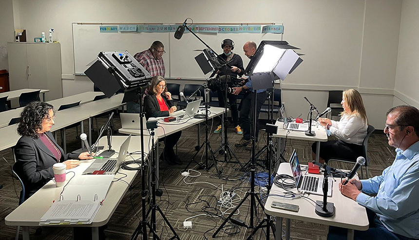 Hearing participants at tables with microphones