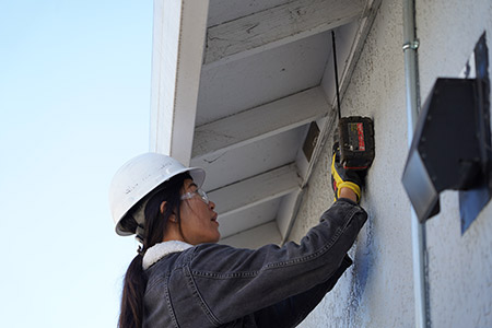 Rachel Wam installing equipment