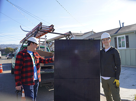 Will Kosinski holding solar panel