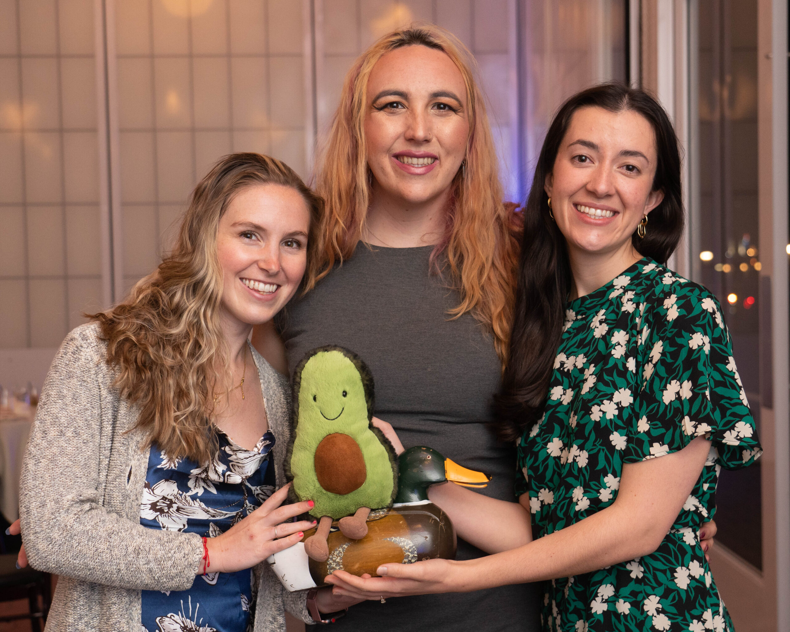 Energy and Environment Students pose with a duck statue and avocado plush doll
