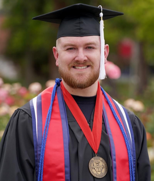 steven hensley in graduation regalia with medal