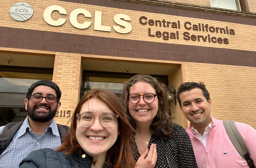 Students smiling in front of Central Cal Legal Services buildling