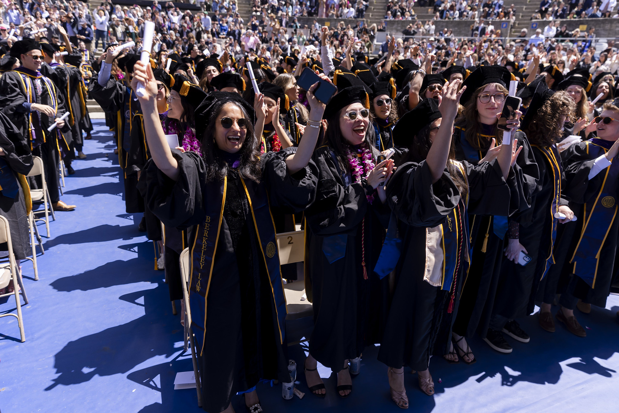 Students in regalia in audience at commencement in the Greek Theatre