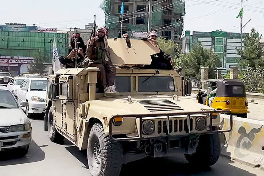Armed Taliban militia patrolling Kabul in a tank