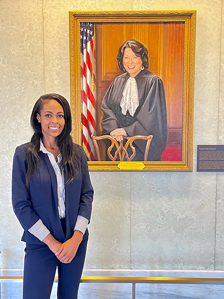 Tiffaney Boyd with portrait of Justice Sotomayor