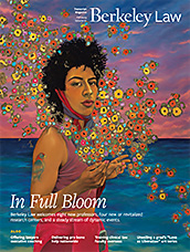 transcript fall 2023 cover, person with bird tattoo by the ocean surrounded by flowers. Links to PDF of magazine