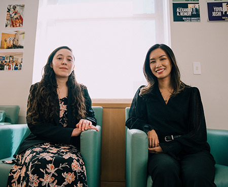 Two students sitting on chairs