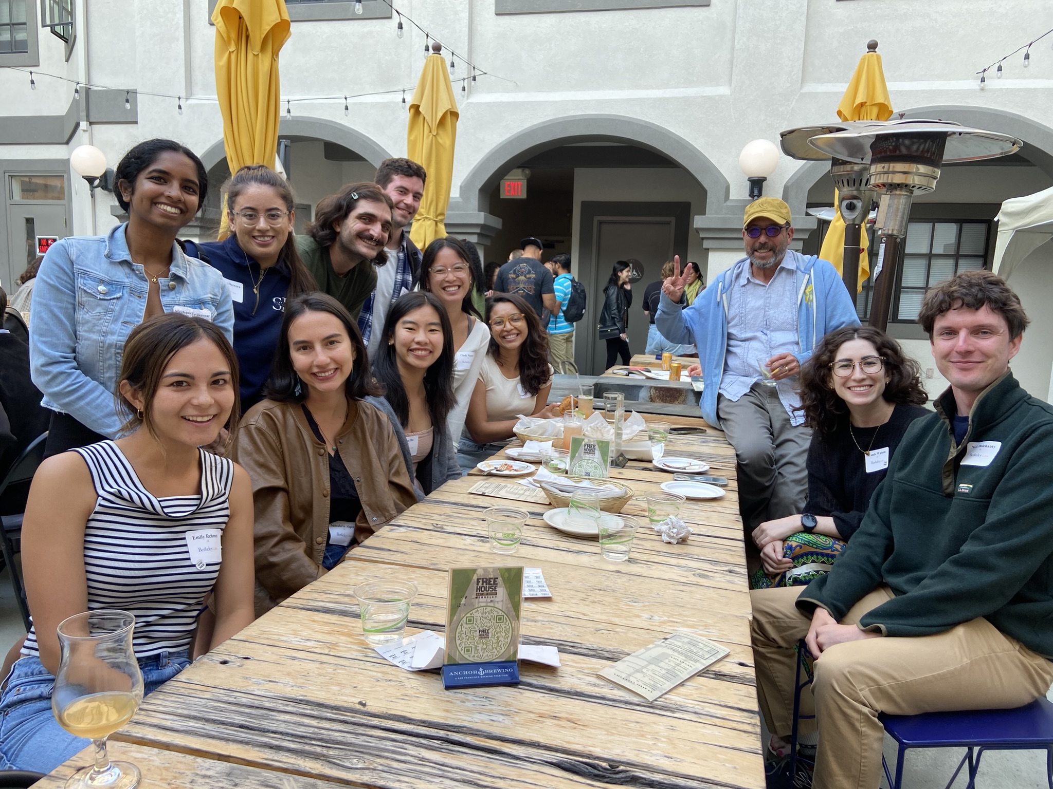 Outside at a local restaurant, the Berkeley Law Public Interest Scholars smile for the camera with faculty mentor, Jonathan Simon.