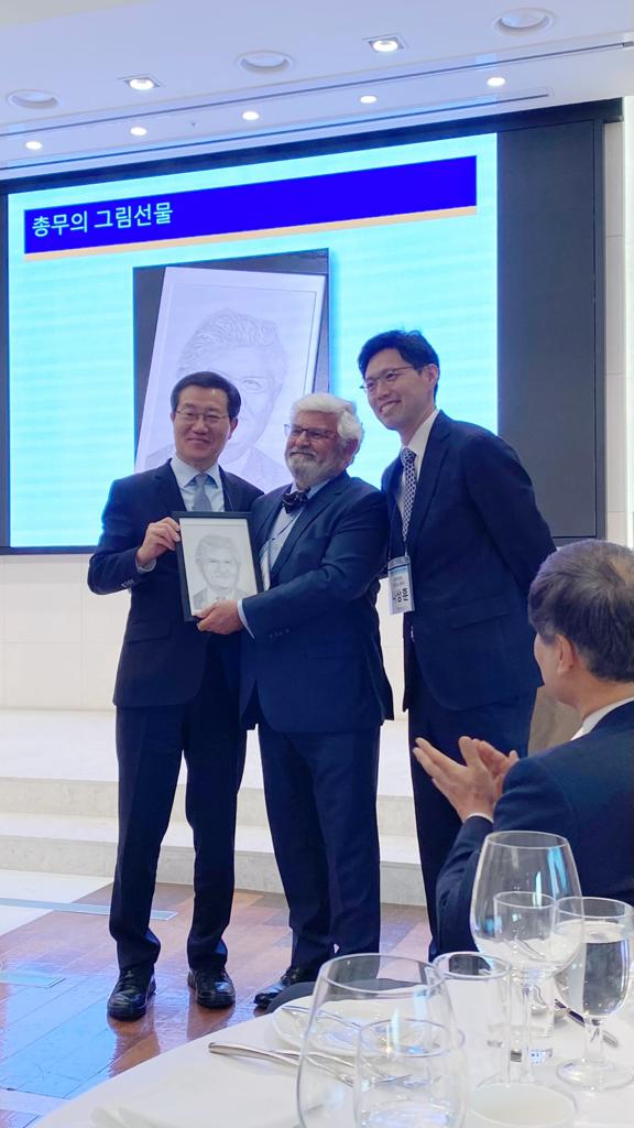 Three people receiving award