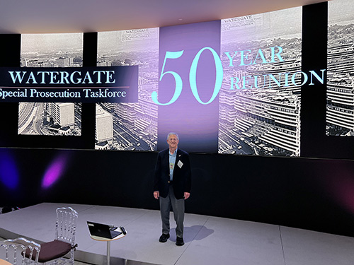 Henry Hecht in front of Watergate presentation sign