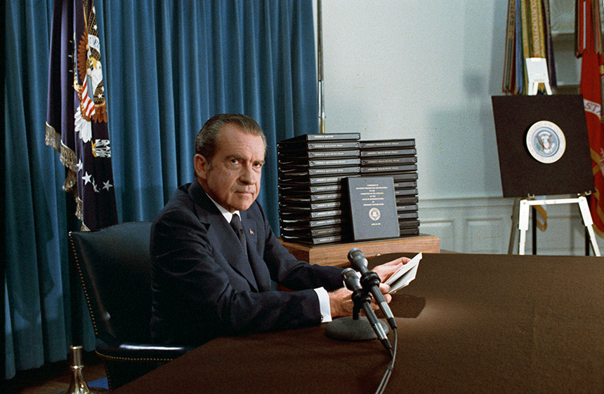 Richard Nixon seated at desk