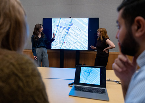 Students viewing a map on a large screen