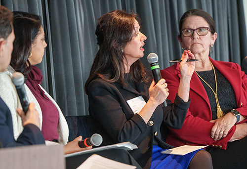 Amelia Miazad seated with microphone