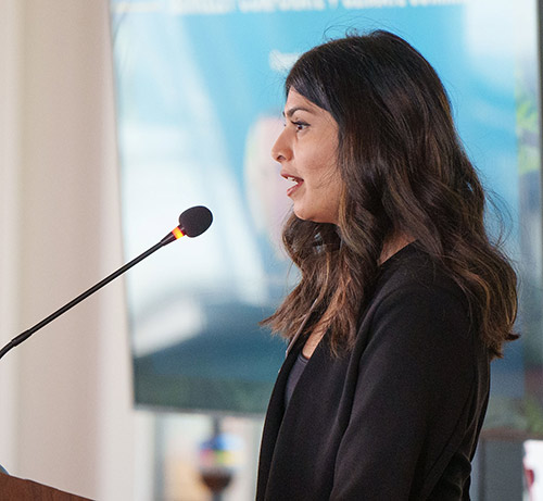 Angeli Patel speaking at podium