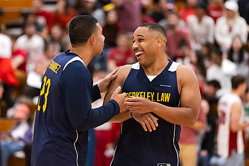 Noah Hernandez (left) and defensive stopper Kevin Steward smiling on basketball court