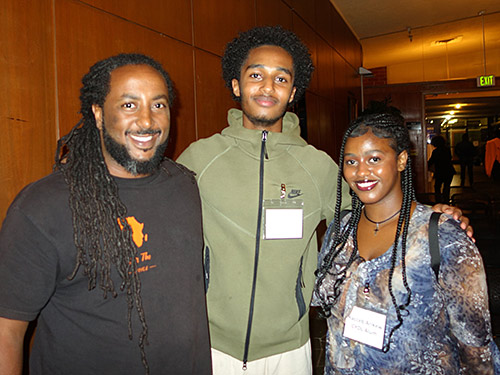 (From left) Yonas Tesfai — part of the center's first student cohort — with Oakland high school seniors Sham Sebhat and Racceb Arikew, who completed the program last summer.