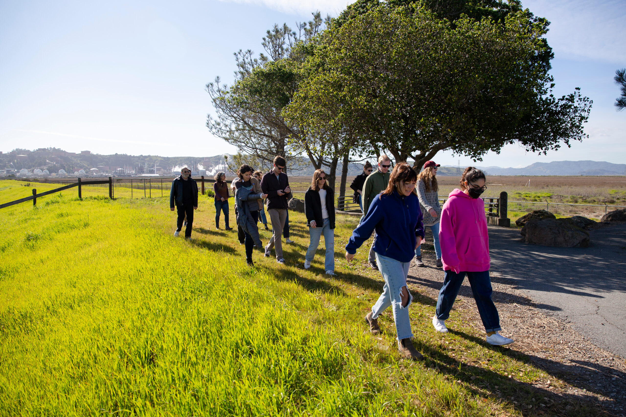 Students on a field trip, walking across a green field
