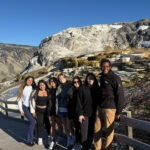 Students posing near mountains in Yellowstone