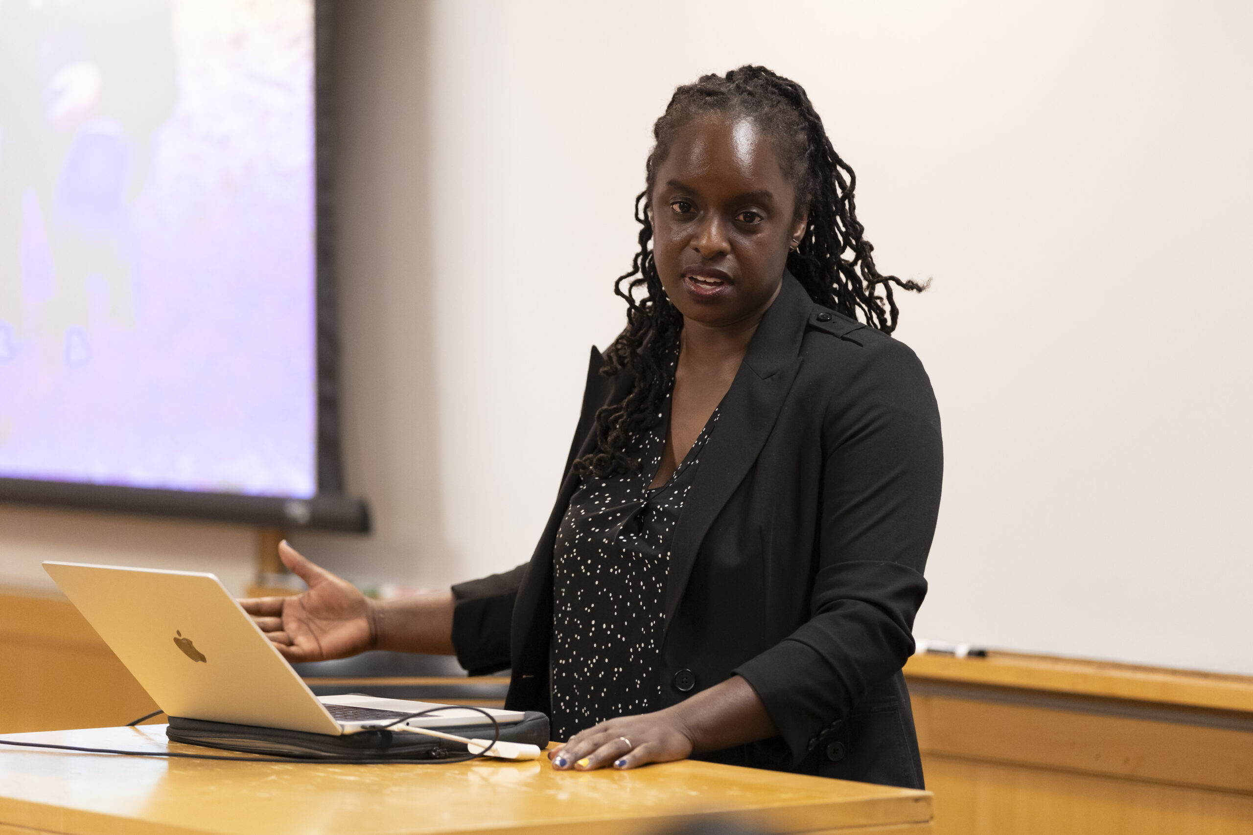 woman at lectern talking to students