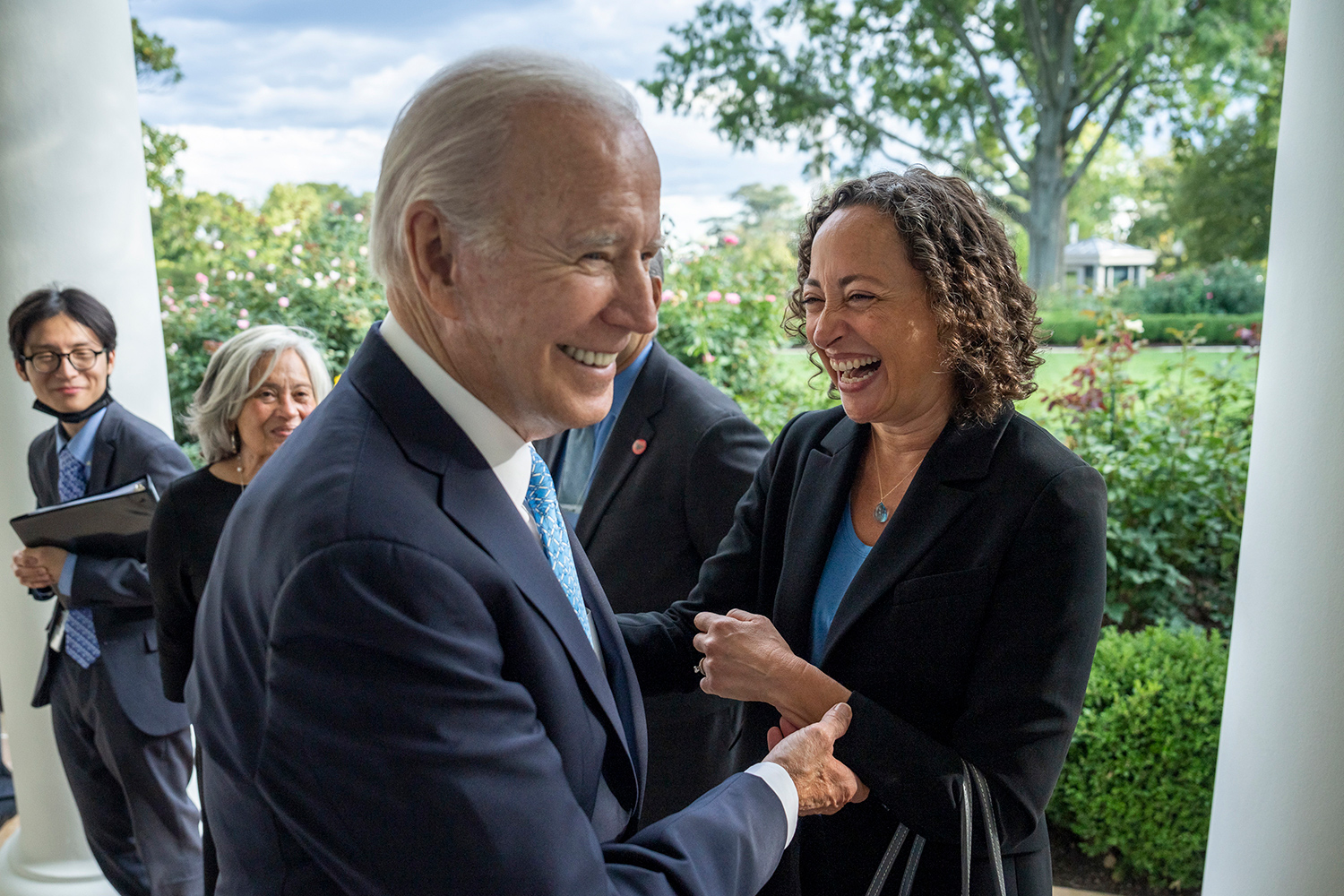 Catherine Lhamon laughing with Joe Biden outside the White House Rose Garden