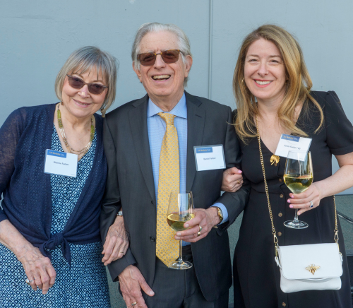 a man and two women smiling