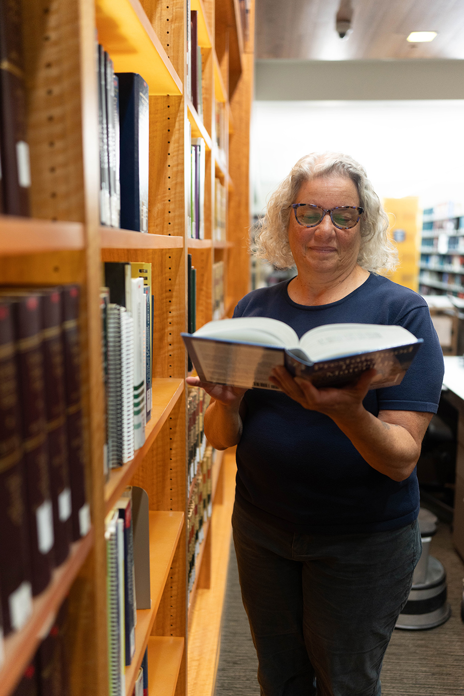 Ramona Collins in the Berkeley Law stacks. Photo by Darius Riley